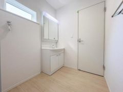 明るい空間に仕上がった洗面所はシンプルで清潔感があります。収納スペースも確保されており日々のお手入れがしやすい仕様です。壁付けミラーも設置されているため実用性も備えています。