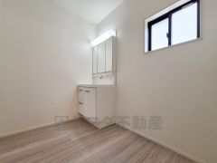 洗面台・洗面所はシンプルで使いやすいデザインが魅力です。明るい照明と清潔感のある空間が広がっています。収納スペースもすっきりとまとまっています。窓からの採光で自然な明るさが感じられます。